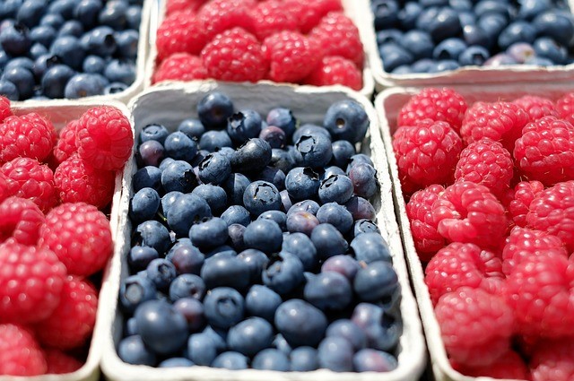 Containers of blueberries and raspberries.