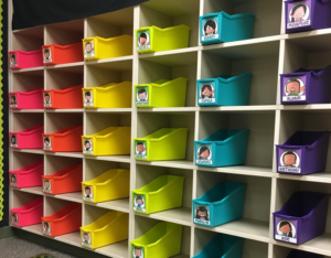 Cubed shelving with a bin in each for students with individual names on them.