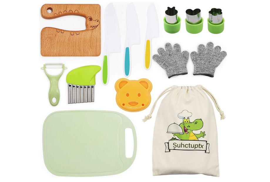 Materials for young children to cook with that includes safe knives, a cutting board, peeler, some cutouts and a bag.