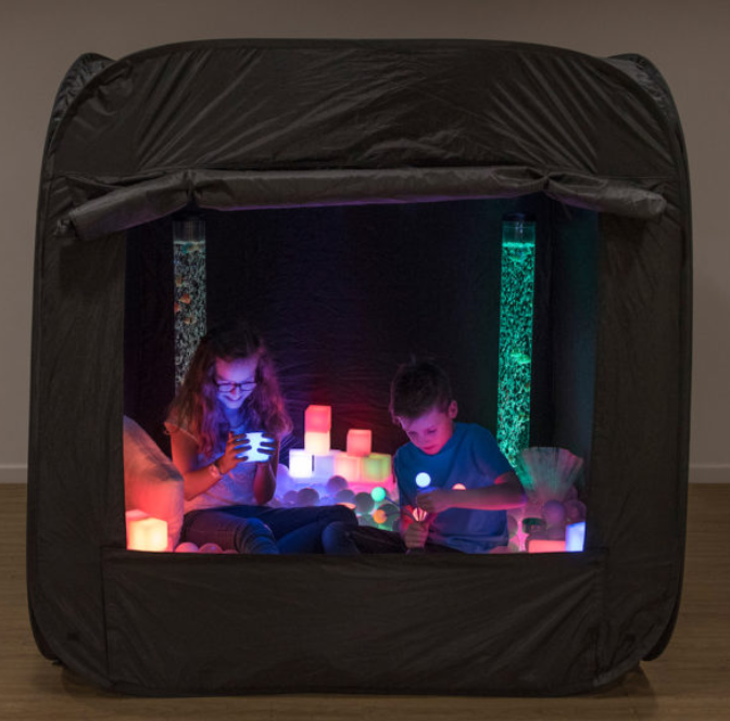 Pop up tent that includes light up objects inside with two students inside looking at them.