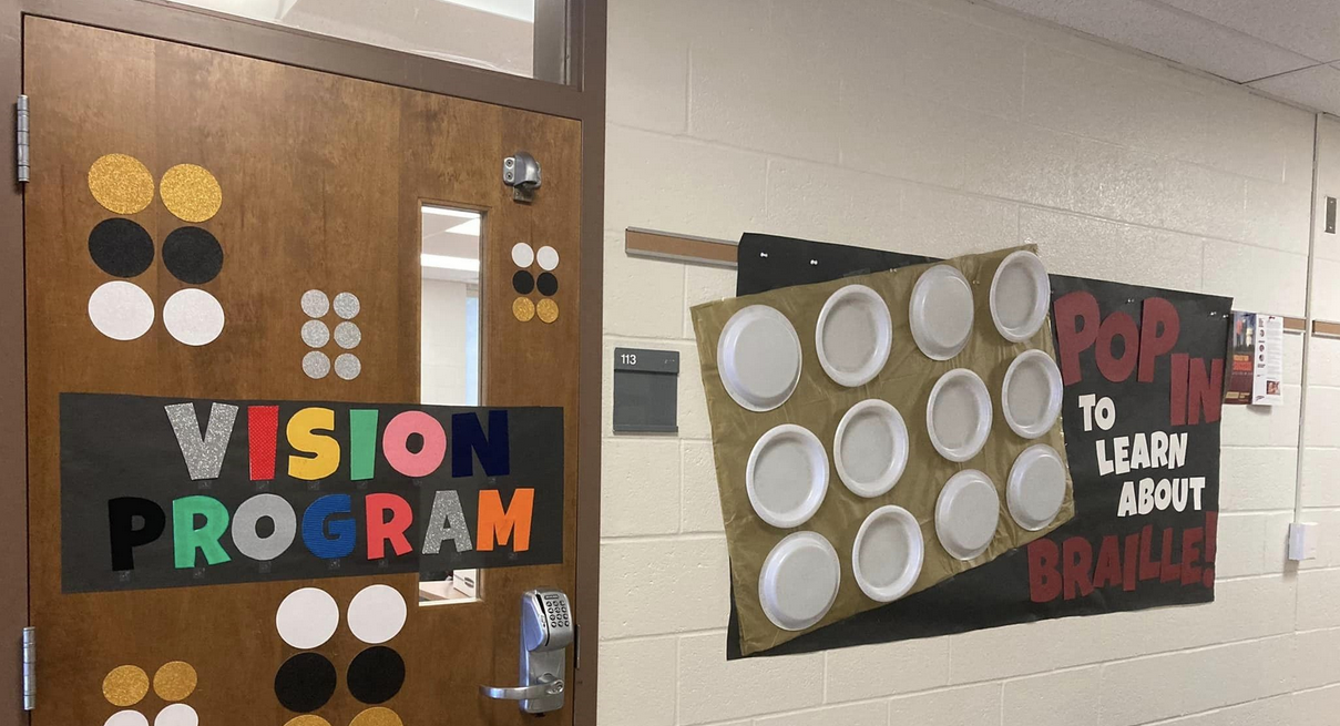 Outside classroom with a braille sign that says Vision Program.