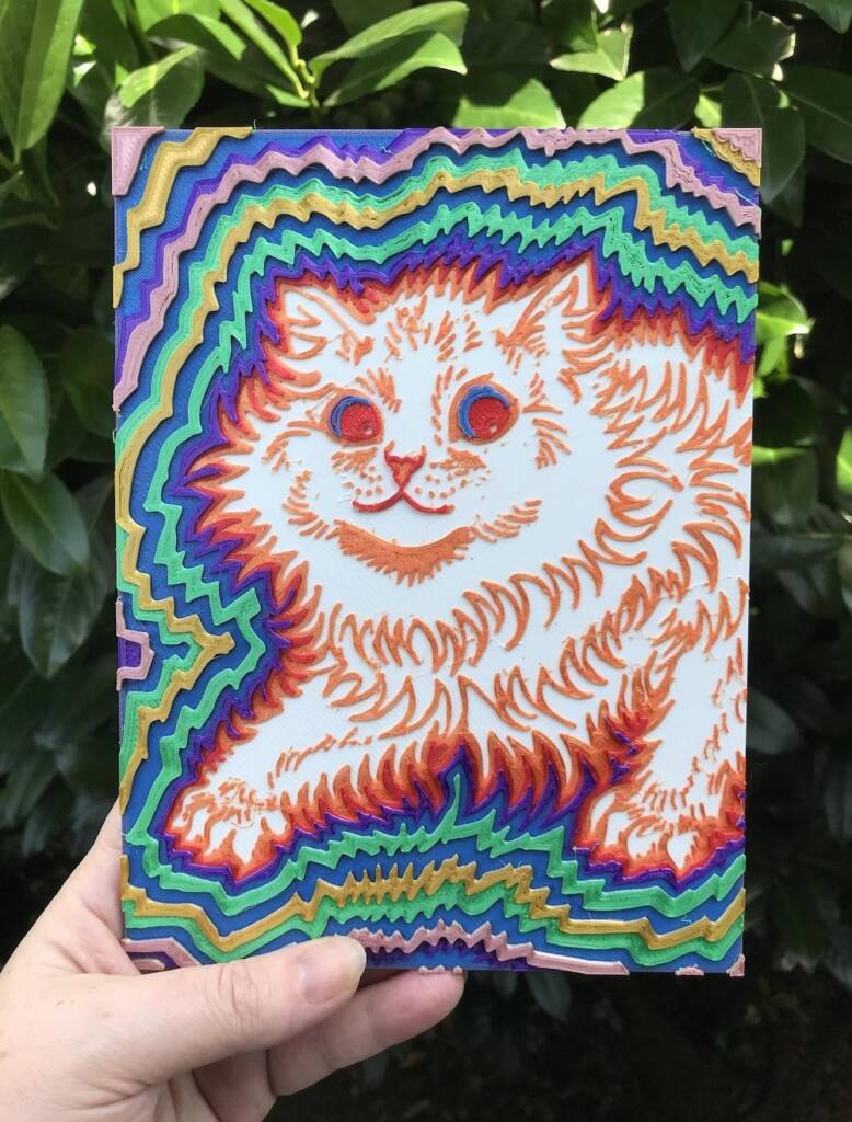 Multi-color 3D printed tactile art piece showing a cat with several lines radiating out from the cat's body. 