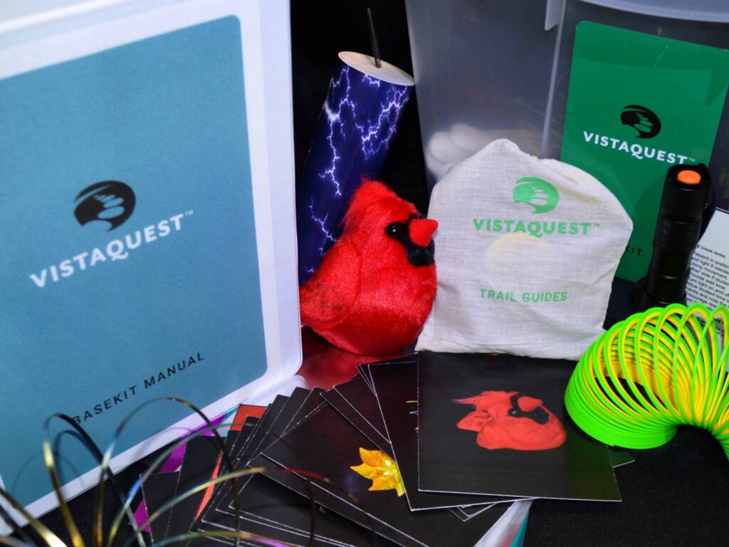 Basekit including various supplies such as a manual, flashcards, slinky, and trail guides