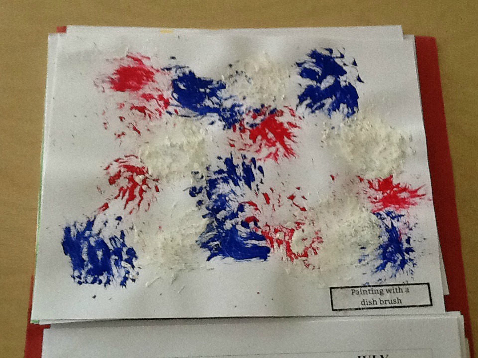 painting of red, white, and blue fireworks made with a dish brush