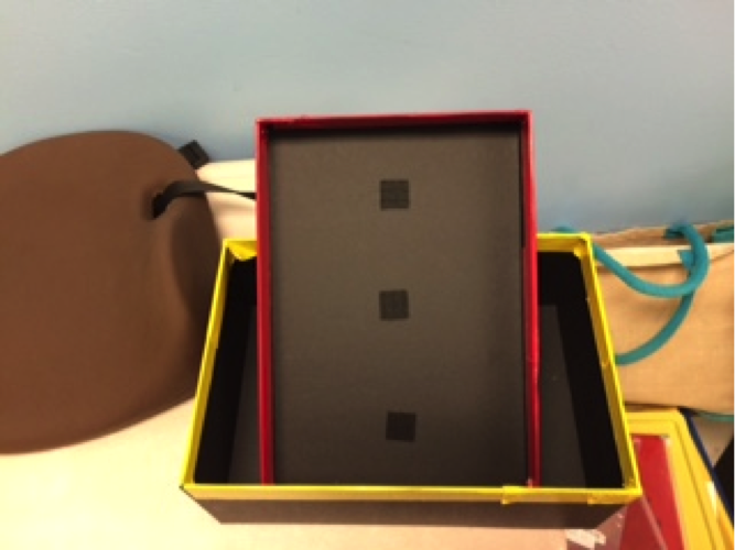 Cardboard box top outlined with red