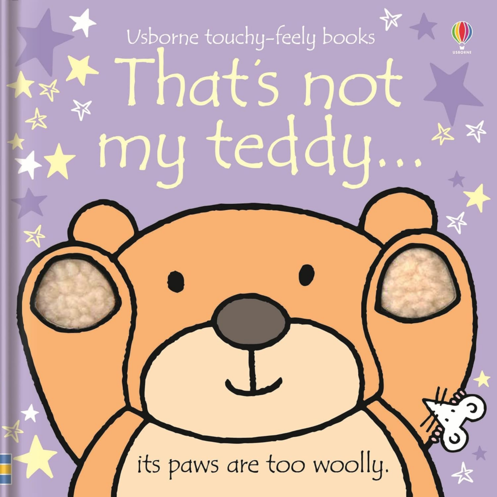 The cover of the book That's not my teddy. The cover shows a teddy bear holding up its furry paws.