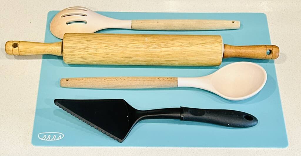 Baking utensils; spoons, rolling pin, and pie scooper.
