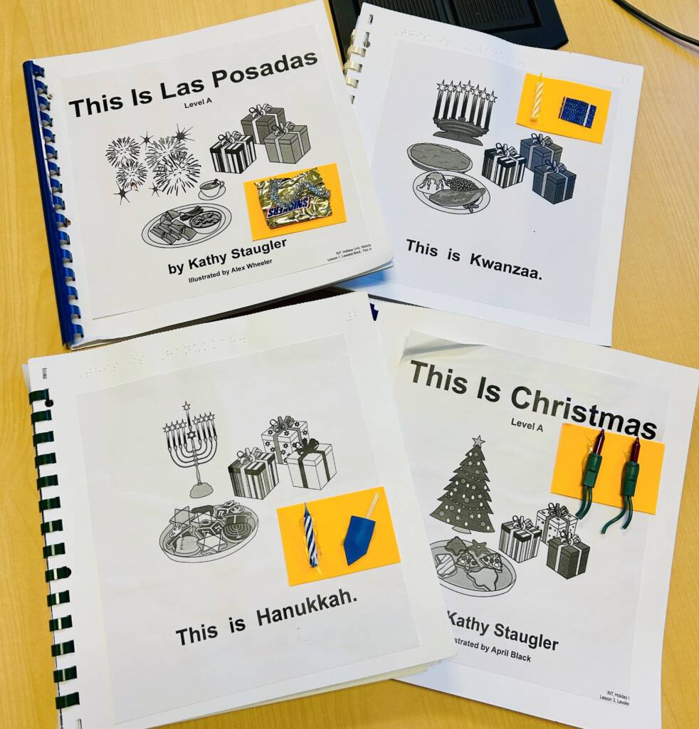 Four braille with print books about Hanukkah, Kwanzaa, and Christmas.