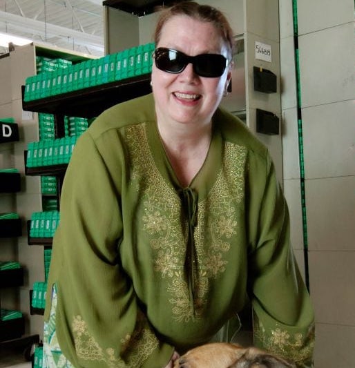 Kim Charlson with guide dog in talking book library