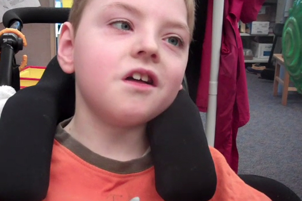 A boy in a wheelchair who exhibits visual latency.