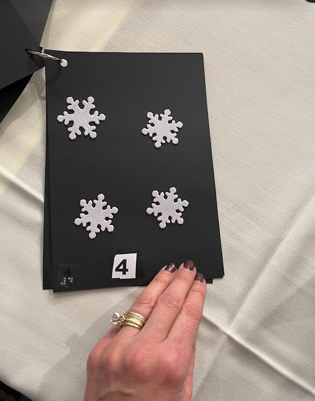 Textured snowflake stickers, four on a page with the number 4 in print and braille.