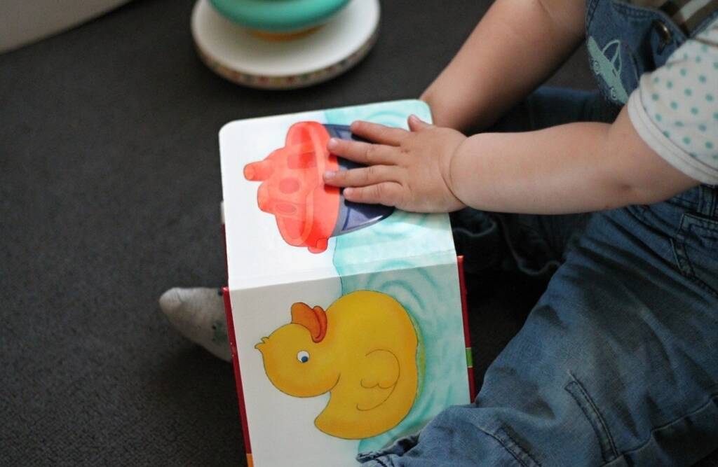 Baby touching book