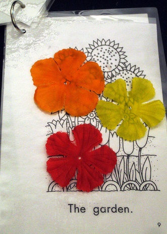 Example of adapted book with fabric flower shapes glued to page