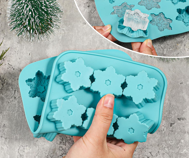 A silicone ice cube tray with four rows of 2 inch snow flake shapes.