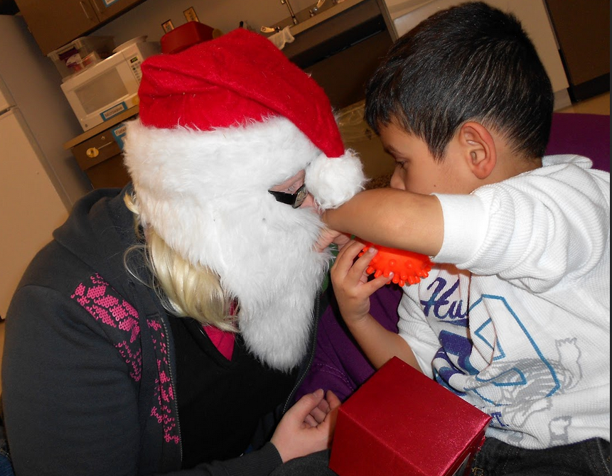 Student exploring teacher dressed as Santa.