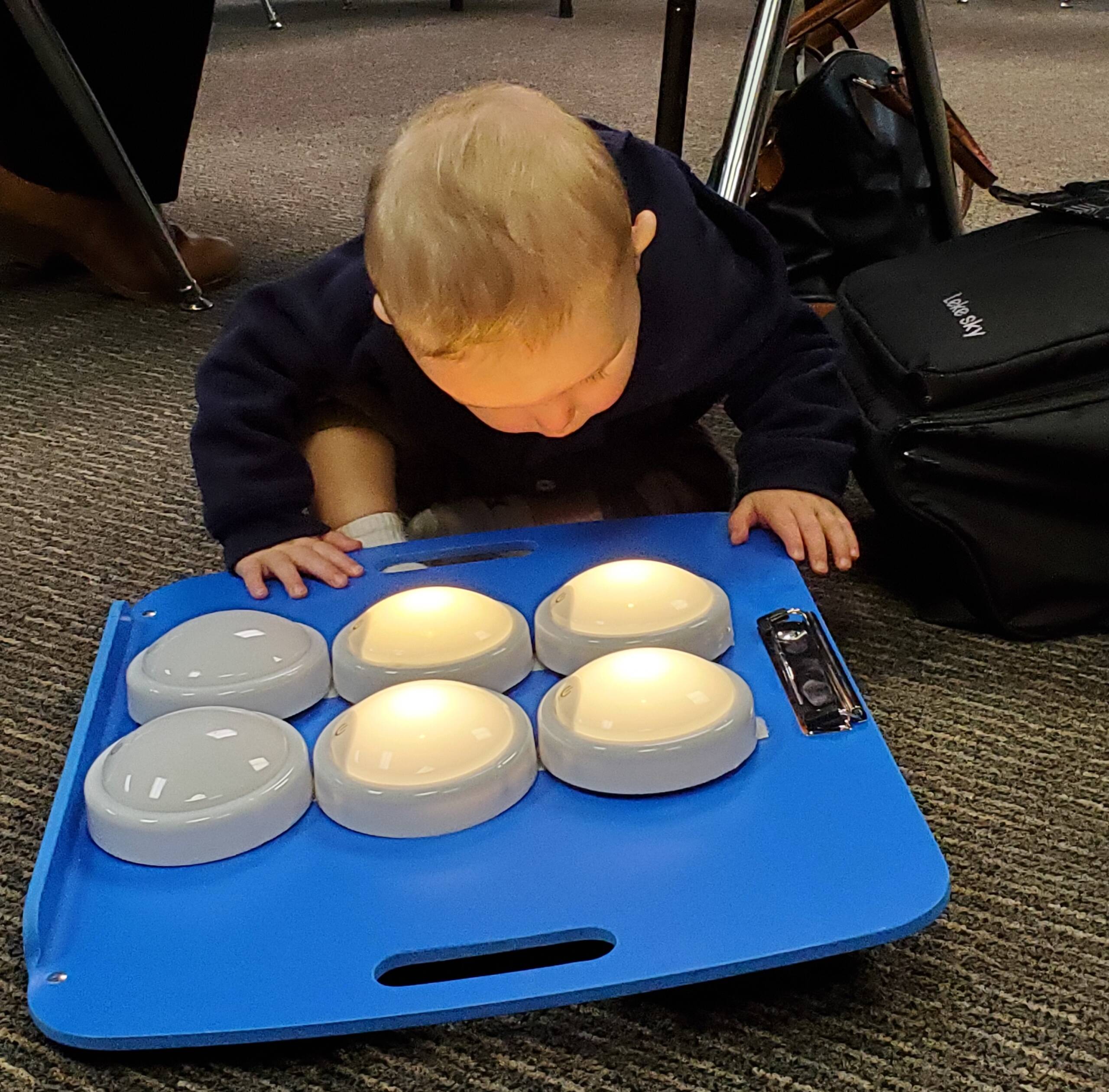 A young child looking at lights