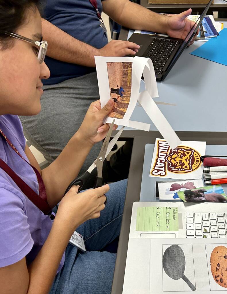 Student cutting out her vision board pictures.