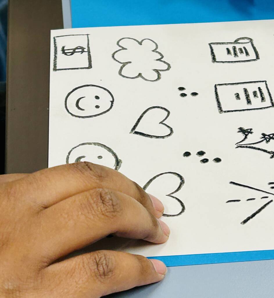 Student exploring tactile images.