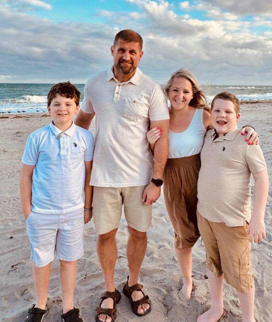 Sandy with her family on the beach.