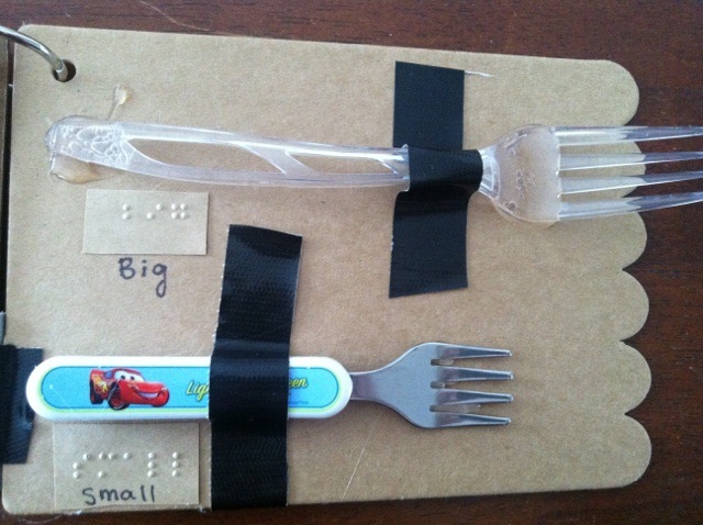 Big and small forks with words "big" and "small" in print and braille