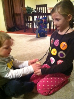 A young boy examines the personal identifier of a girl