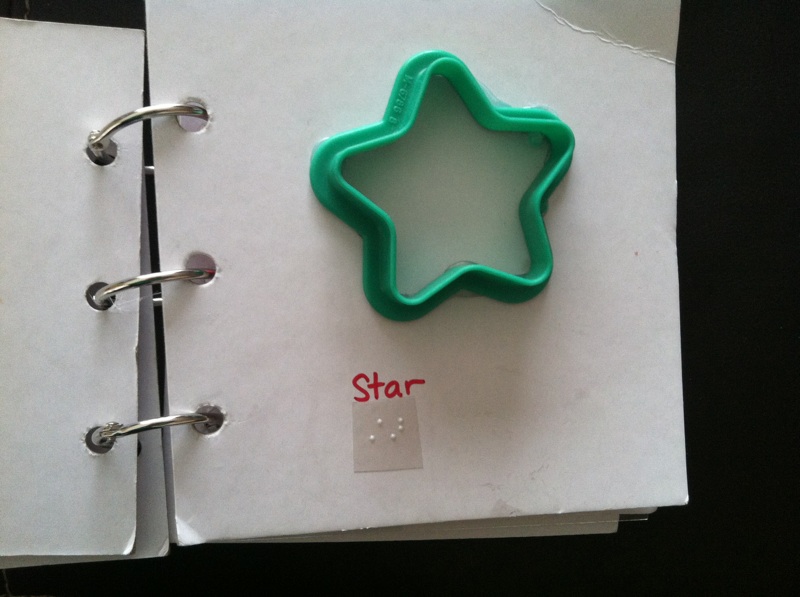 Star shape with "star" in print and braille