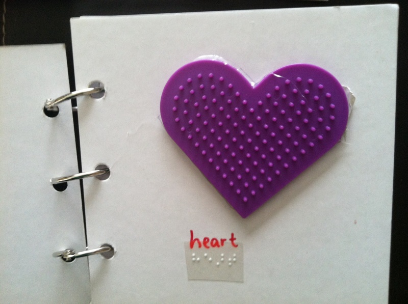 Textured heart with "heart" in print and braille