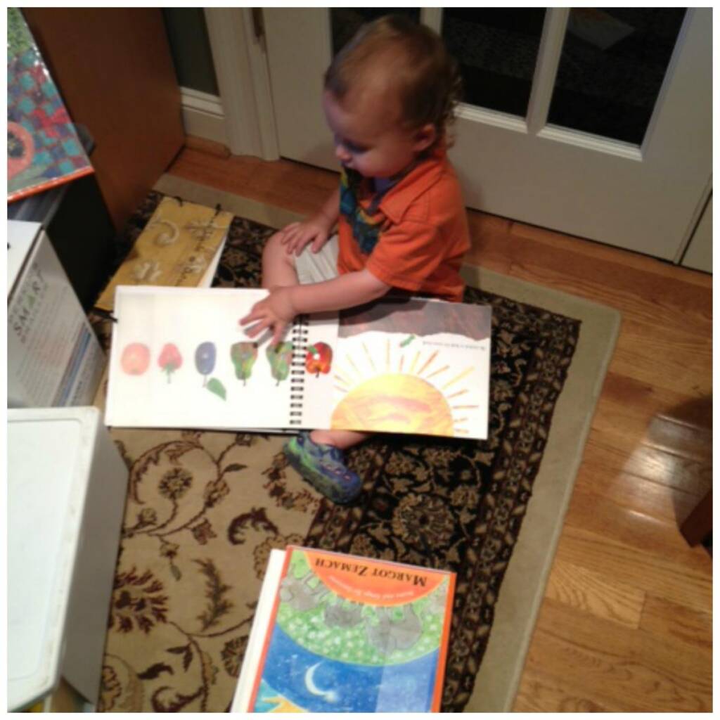 A toddler on the floor with picture books