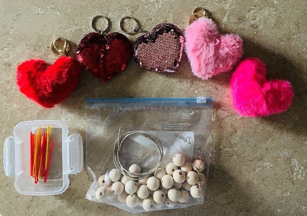 Materials to make a garland out of wood and felt hearts