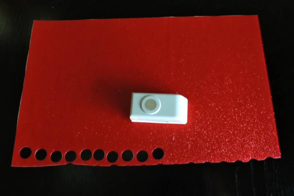 Paper punch on textured red materials