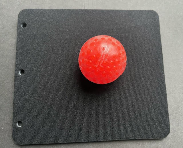 Red ball on a black page