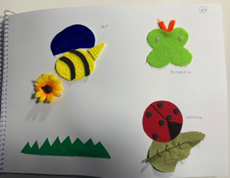 A page of a book with tactile images of a bee, butterfly, and ladybug