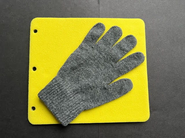 Grey glove and yellow page
