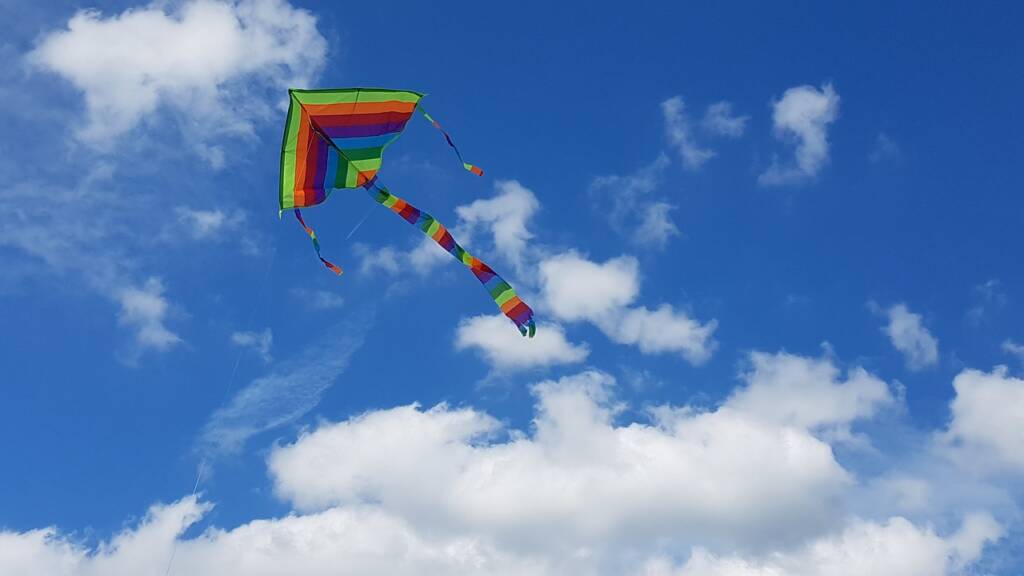 A kite flying in the sky amongst clouds