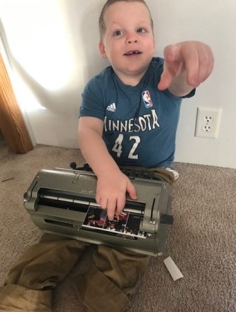 Young boy using his Perkins brailler