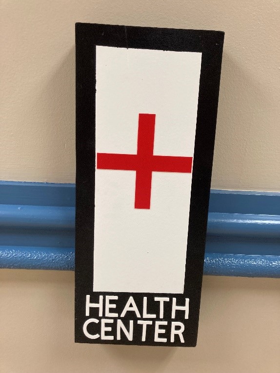 A sign with a red cross on it that says "health center"