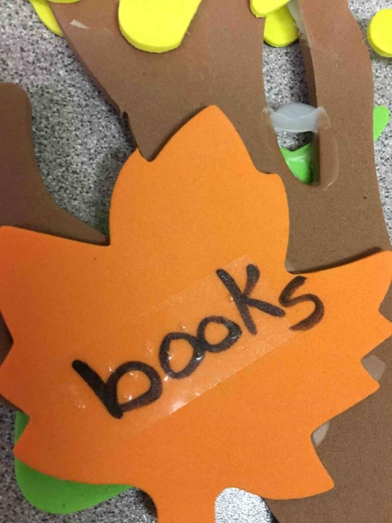 Orange leaf with "books" in print and braille