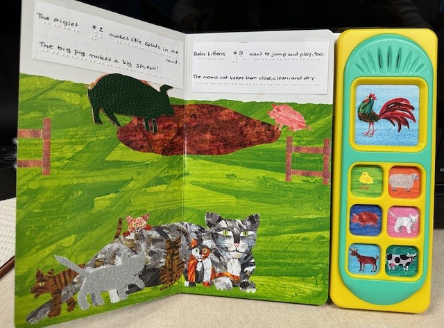 A page of the book Farm Babies. Shown are pigs and cats. One of the pigs and one of the cats are covered in tactile paper in the shape of the animal. The sentences of the book are displayed in both print and braille.