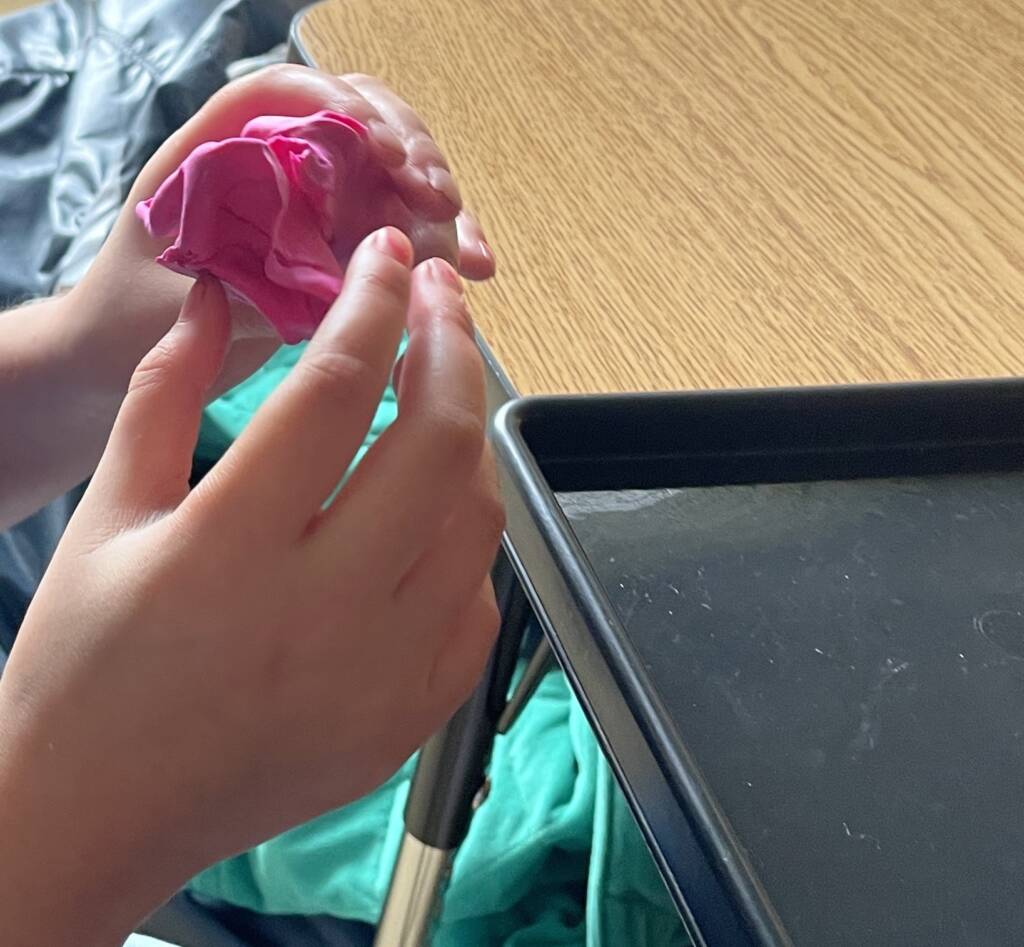 Student molding clay.