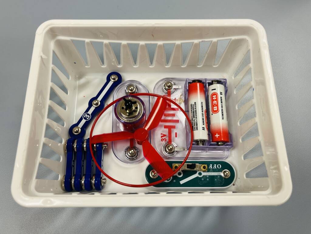 The various parts of the access kit in a small bin.