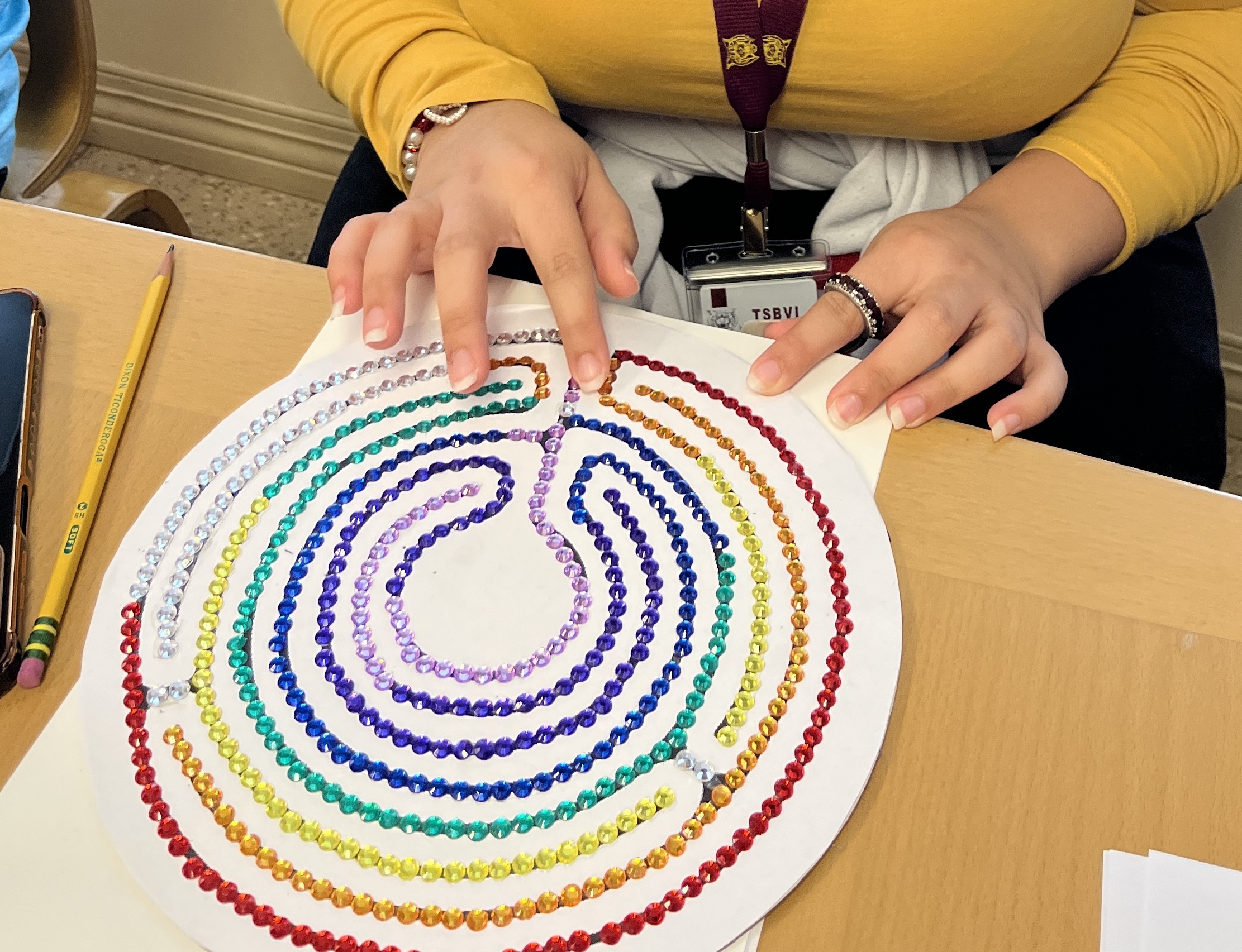 Beaded labyrinth being explored by a student