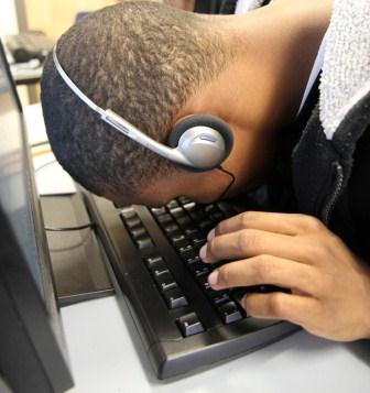 Student looking at computer keyboard at very close range