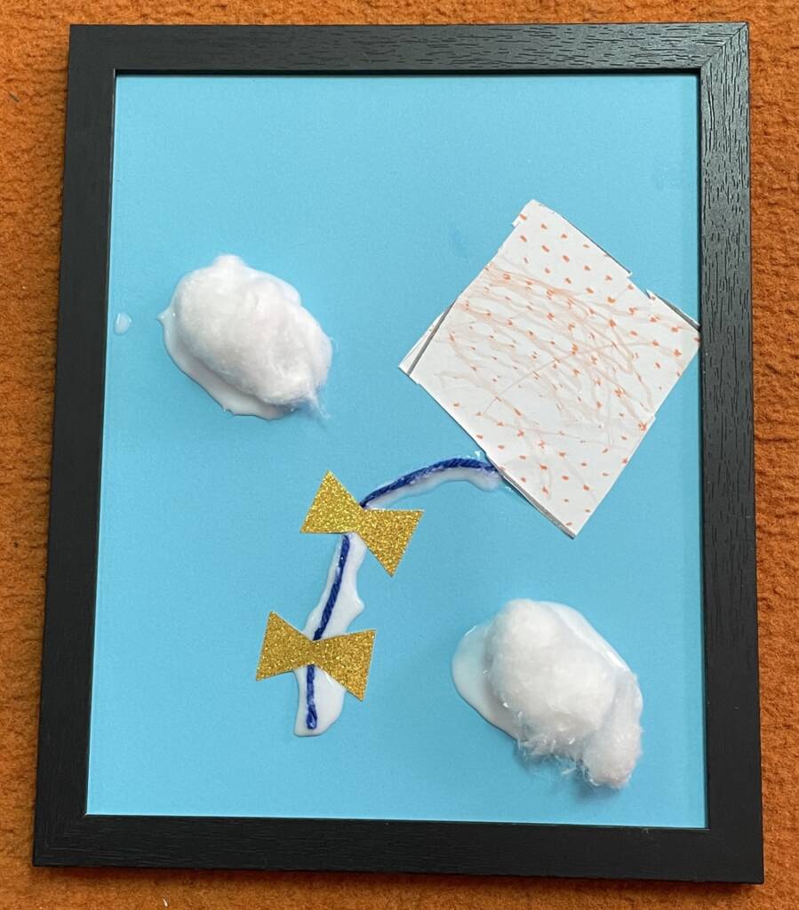 Tactile craft with a kite and puffy clouds in the sky