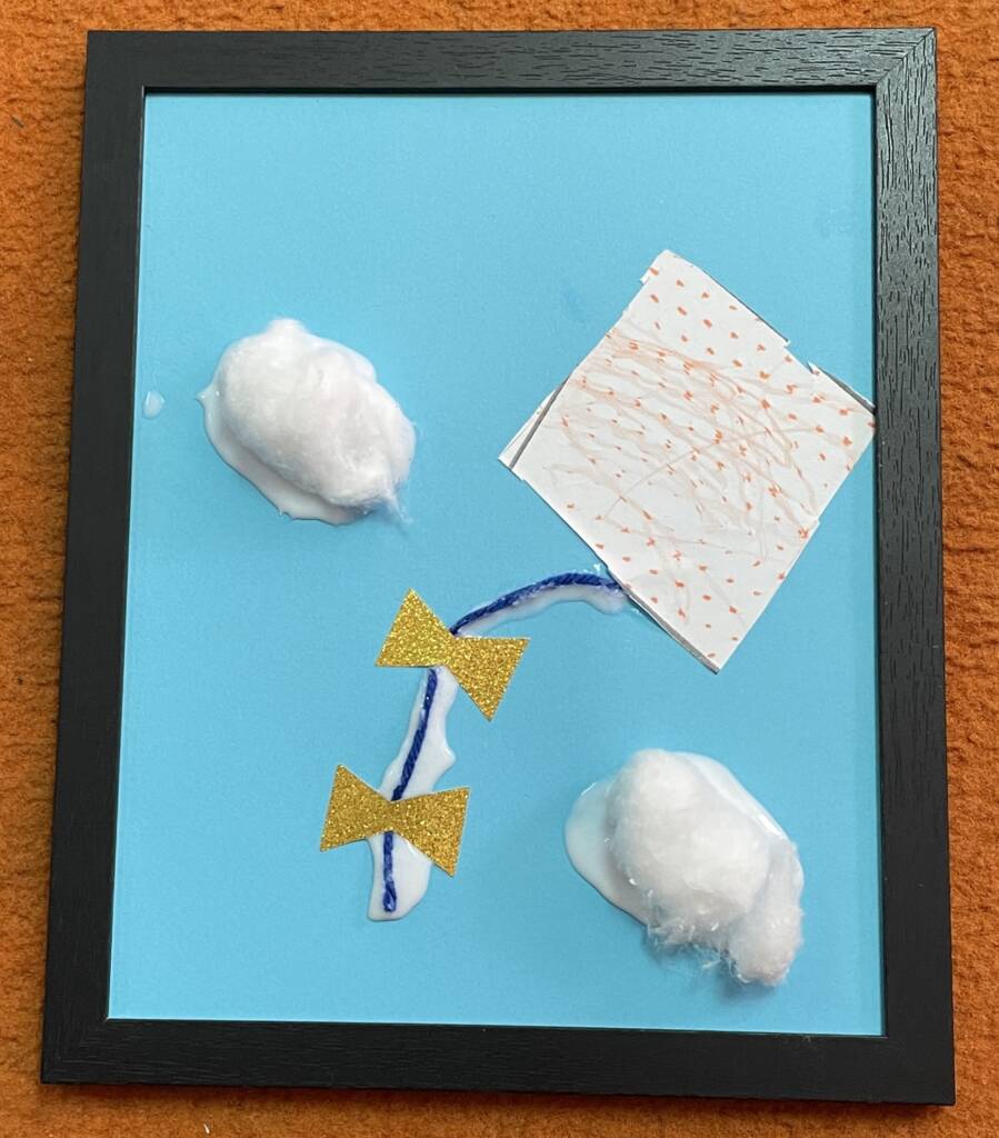 Tactile craft with a kite and puffy clouds in the sky