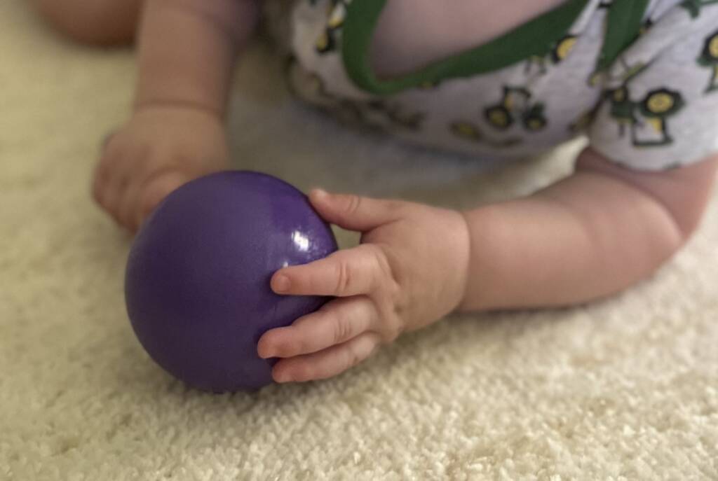 Baby holding a rattle