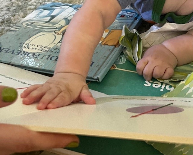 Baby touching a tactile book.