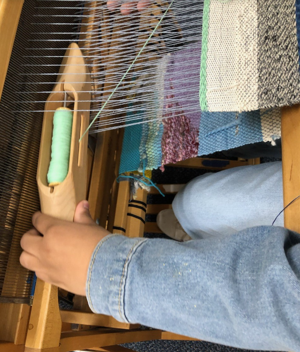 Weaving on a large loom machine.