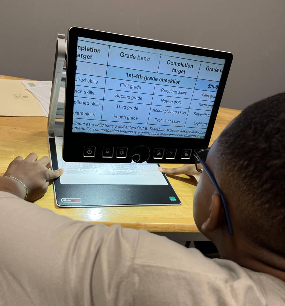 A boy using a video magnifier