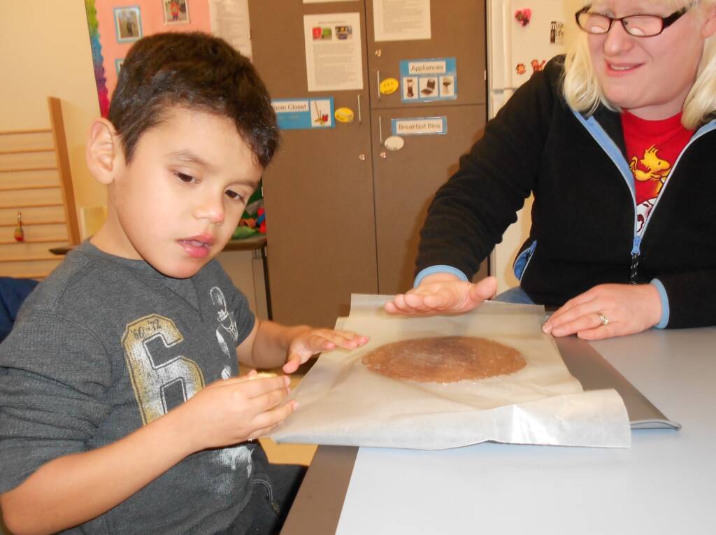 Student with dough on table with Kathi