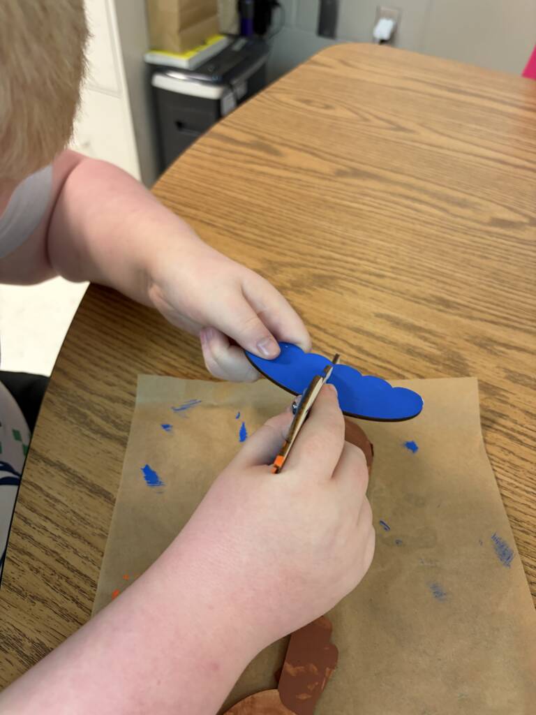 Student assembling the wooden bird. 